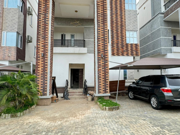 a building with a brick wall and a car parked in front of it