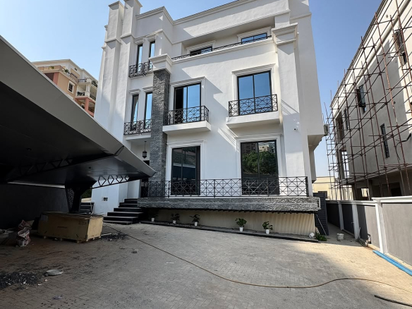 Front View: "Elegant 7-bedroom fully automated detached home with a modern facade in Asokoro, Abuja."